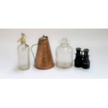 A vintage Schweppes soda siphon; conical copper jug; pair of binoculars and a demijohn