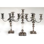 A pair of three arm candlesticks, marked 'silver plated on copper, S. Ltd', 36cmH; together with one