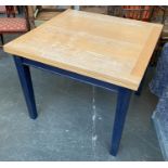 A 1970s drawer leaf kitchen table, beech top on a blue stained base, 90x90x74cmH, each leaf adding