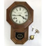 A Seth Thomas octagonal wall clock, with pendulum and key