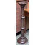 A mahogany pot stand on a spiral carved column and turned base, 101cmH
