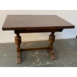 A 20th century oak drawer leaf table, on cup and cover supports, 106x76x75cmH