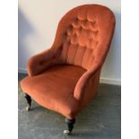 A Victorian button back bedroom chair, on ebonised turned legs and ceramic casters, 63cmW