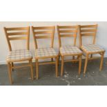 A set of four beechwood kitchen chairs with upholstered seats
