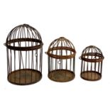 A graduated set of hanging bird cages, the largest 40cmH