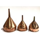 A lot of three copper funnels, the largest 28cm high