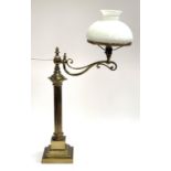 A gilt brass oil lamp, converted for use electrical use, with reeded column and adjustable arm, on