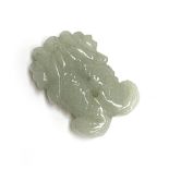 A Chinese carved celadon jade pendant in the form of two fish, 3.3cmL