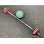 A barbell with 7kg of weights; together with a 2kg exercise ball