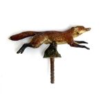 A cold painted car mascot in the form of a running fox, 13cm long