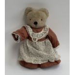 A Merrythought teddy bear with dress and Hampshire Teddy Bear Festival 1995 badge, approx. 36cmH
