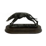 A resin figure of a coursing greyhound, the plinth 32cm long