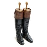 A pair of black leather hunting boots, approx. size 8, with later added mahogany tops, full wooden