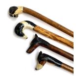 A lot of four walking sticks, each with painted carved terminals in the form of dogs - doberman
