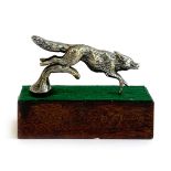 A Desmo car mascot modelled as a leaping fox, approx. 11cm long, mounted on a mahogany base