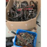 A large quantity of leather tack, including head collars, stirrup irons, and bits, etc