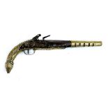 An early 19th century brass mounted flintlock pistol, decorated with scrolls