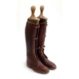 A pair of early 20th century brown leather field boots with fitted wooden trees, approx. size 9/10