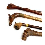 A lot of four gent's walking sticks, all with carved terminals, one in the form of a bulldog (4)