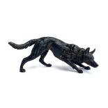 A patinated bronze of a hound, 15cm long