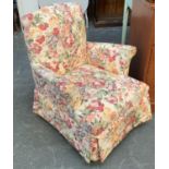 A small bedroom armchair, upholstered in a floral print, 70cmW