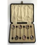A cased set of six George V silver and guilloche enamel bean terminal coffee spoons, William