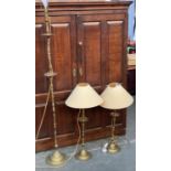 A matched pair of tall brass table lamps, with shades, 85cmH to top of shade; together with a
