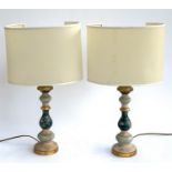 A pair of Italian polychrome and parcel gilt turned wood table lamps, with oval semi-open shades,