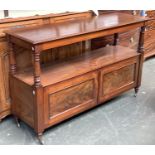A 19th century mahogany two tier buffet, with cupboards below, fielded panel cupboard doors, on
