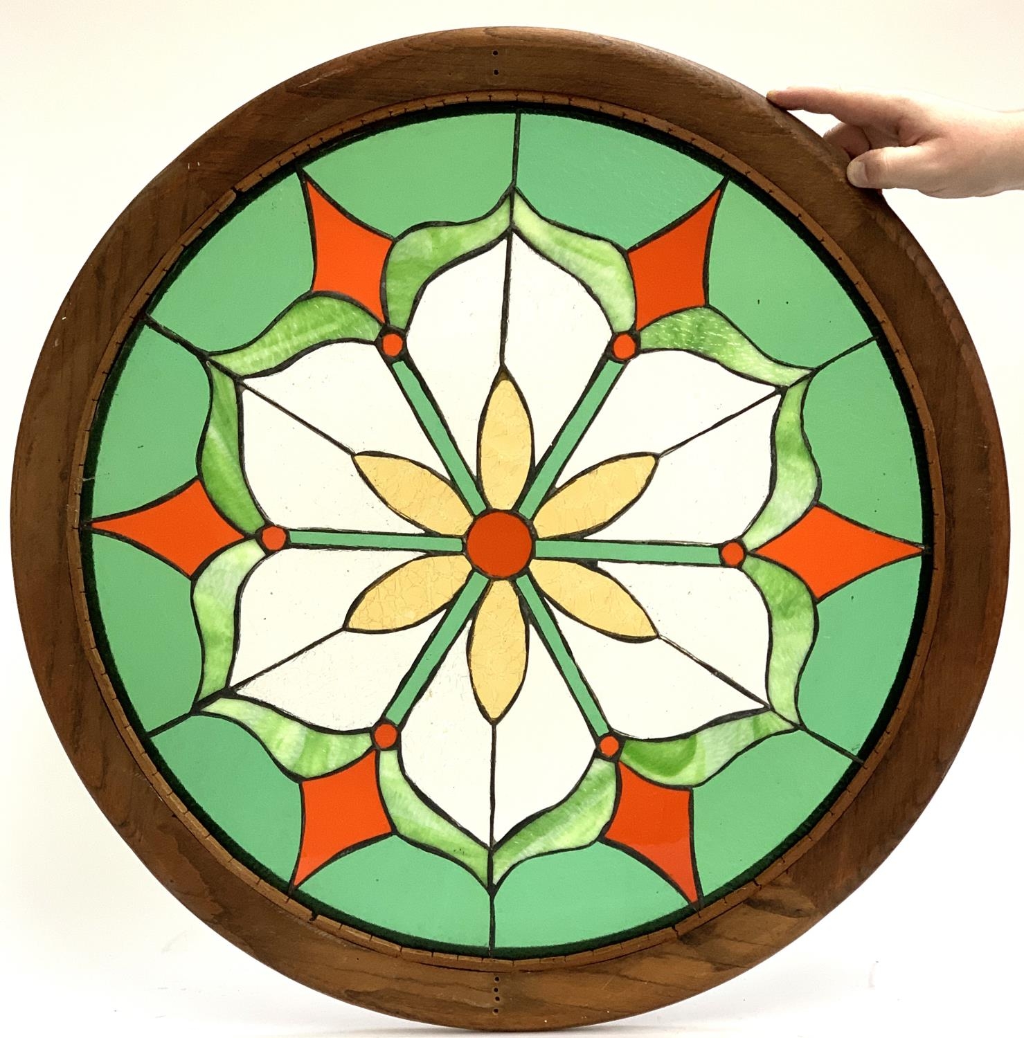 A stained glass floral roundel, 70cmD including frame