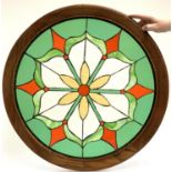 A stained glass floral roundel, 70cmD including frame