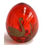 A Russian Faberge style cranberry glass egg, with engraved gilt decoration of swans and rushes, 6cmH