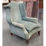 A Victorian wingback armchair, on turned legs and casters, 84cmW; with newspaper found under