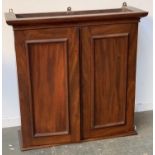 A Victorian mahogany wall hanging cupboard, two doors opening two shelves, 76x26x76cm