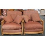 A pair of contemporary Ercol light oak armchairs, upholstered in a small check fabric, approx. 90cmW