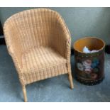 A leather clad waste paper bin, hand painted with a basket of roses; together with a wicker child'