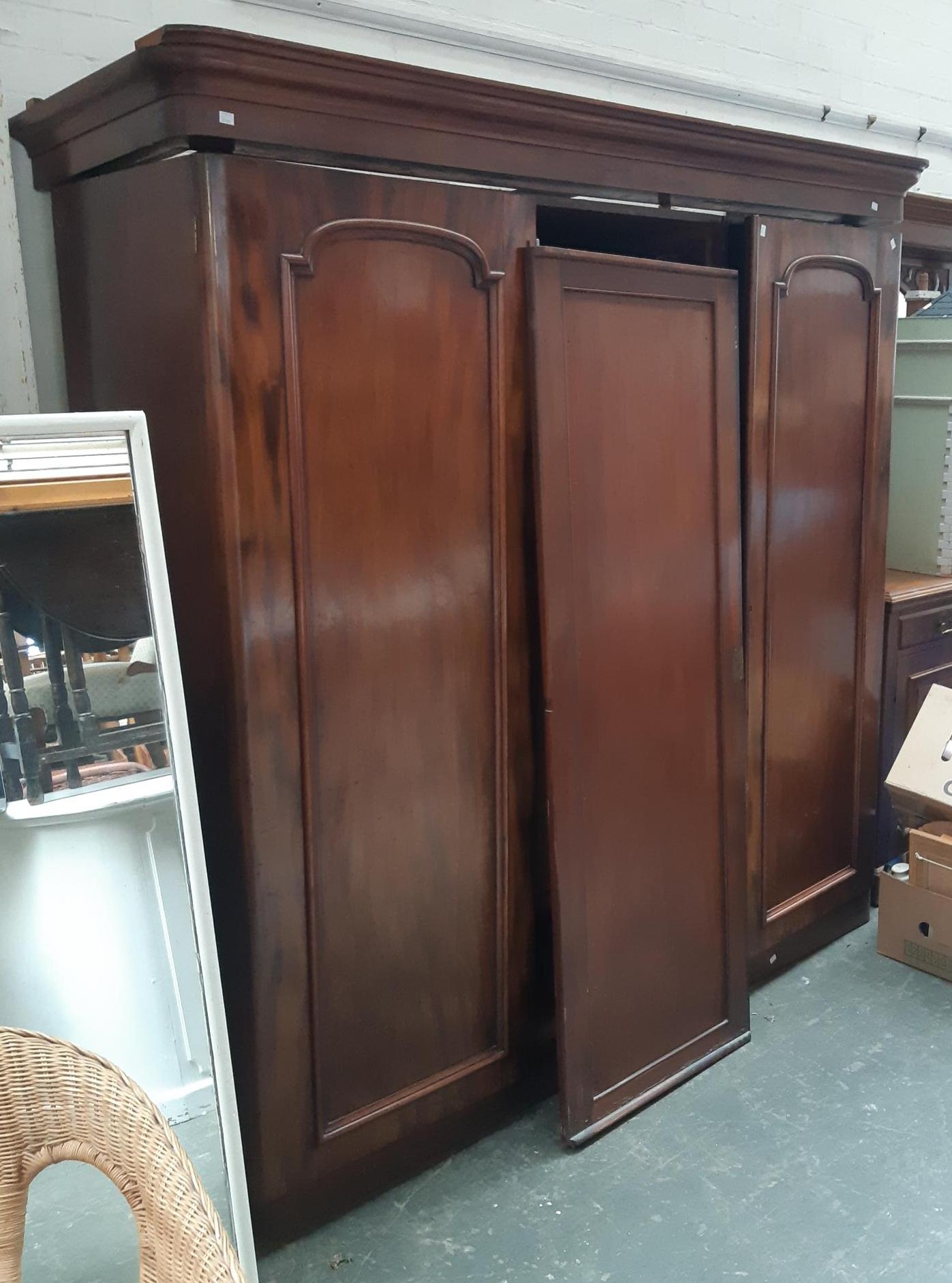 A Victorian mahogany gents three part compactum wardrobe, with hanging rail and right-hand section