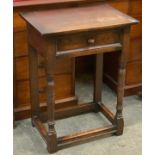 A 17th century style oak side table, with single drawer and turned legs, on peripheral stretchers,
