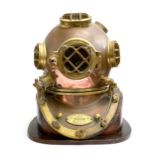 A Brass and copper US navy diving helmet, bears a label "U.S.Navy Diving Helmet Mark V, Morse Diving