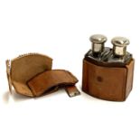 A leather cased set of two shaped glass spirit flasks, with nickel tops, the leather case AF, 11.