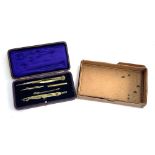 A cased set of drawing instruments, velvet and silk lined, with blank brass plaque to lid