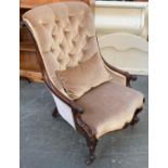 A Victorian rosewood buttonback salon chair, serpentine seat with carved rail, on scrolling cabriole