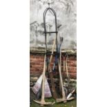 A wrought iron garden rose trellis, 205cmH, together with a selection of garden tools