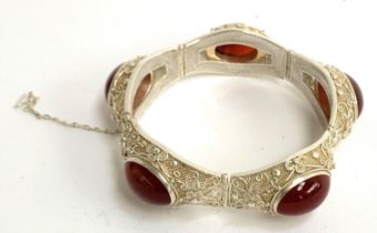 An early 20th century Chinese export silver filigree bracelet set with carnelian cabochons, with