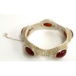 An early 20th century Chinese export silver filigree bracelet set with carnelian cabochons, with