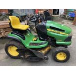 A John Deere 100 series model X140 ride on lawn mower, 48 inch cutting system, with key
