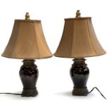 A pair of modern ceramic table lamps with shades