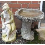 A composite stone figure of a seated nude, 60cmH together with a composite stone garden birdbath,