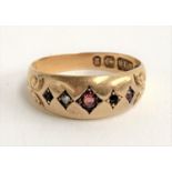 An 18ct gold gypsy ring set with garnets and a diamond (one diamond missing), approx. 2.9g, size