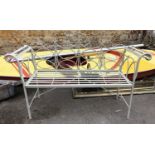 A collapsible painted metal garden bench with scrolled arm supports, 140cmW